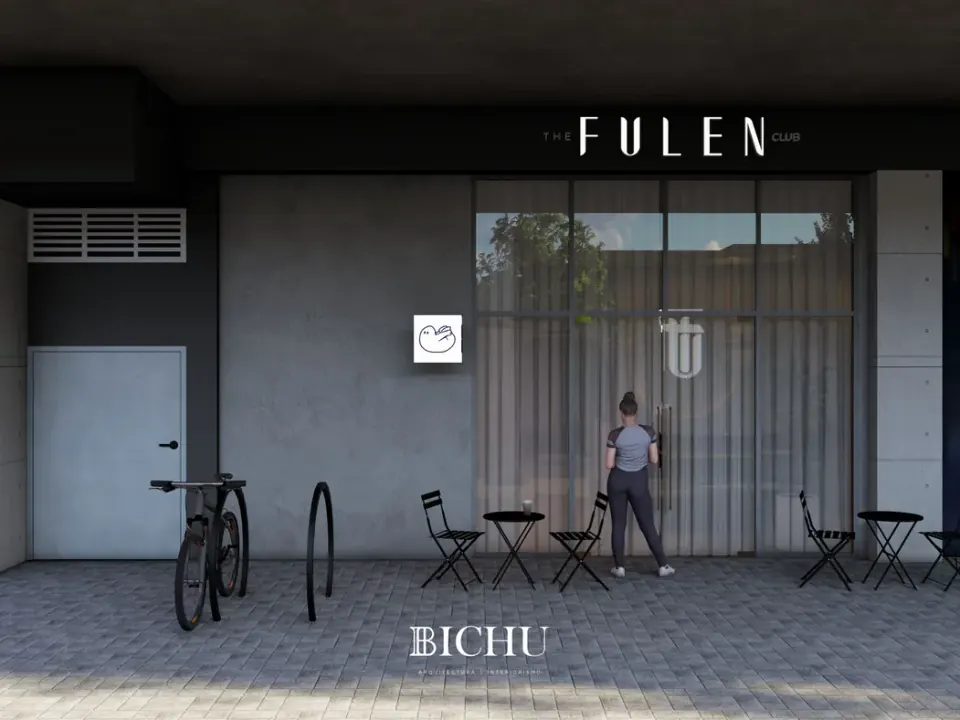 Fachada con el letrero The Fulen Club, puerta de cristal con cortinas, mesas plegables y bicicletero en la banqueta