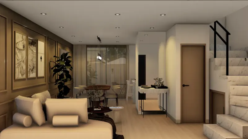 Sala vista hacia el comedor y la escalera, con cuadros enmarcados, planta de hojas grandes y consola clara